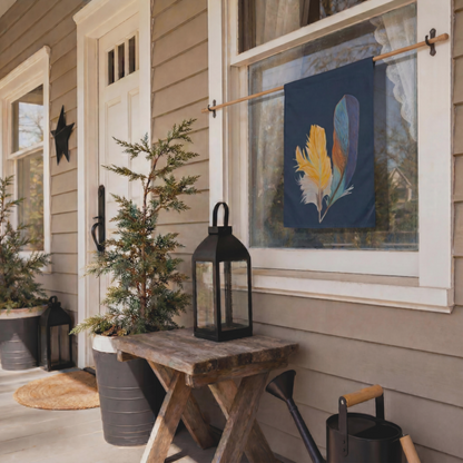 Front porch with hand drawn kingfisher feather garden flag, wooden table, potted plants, and decorative lantern on a house exterior.
